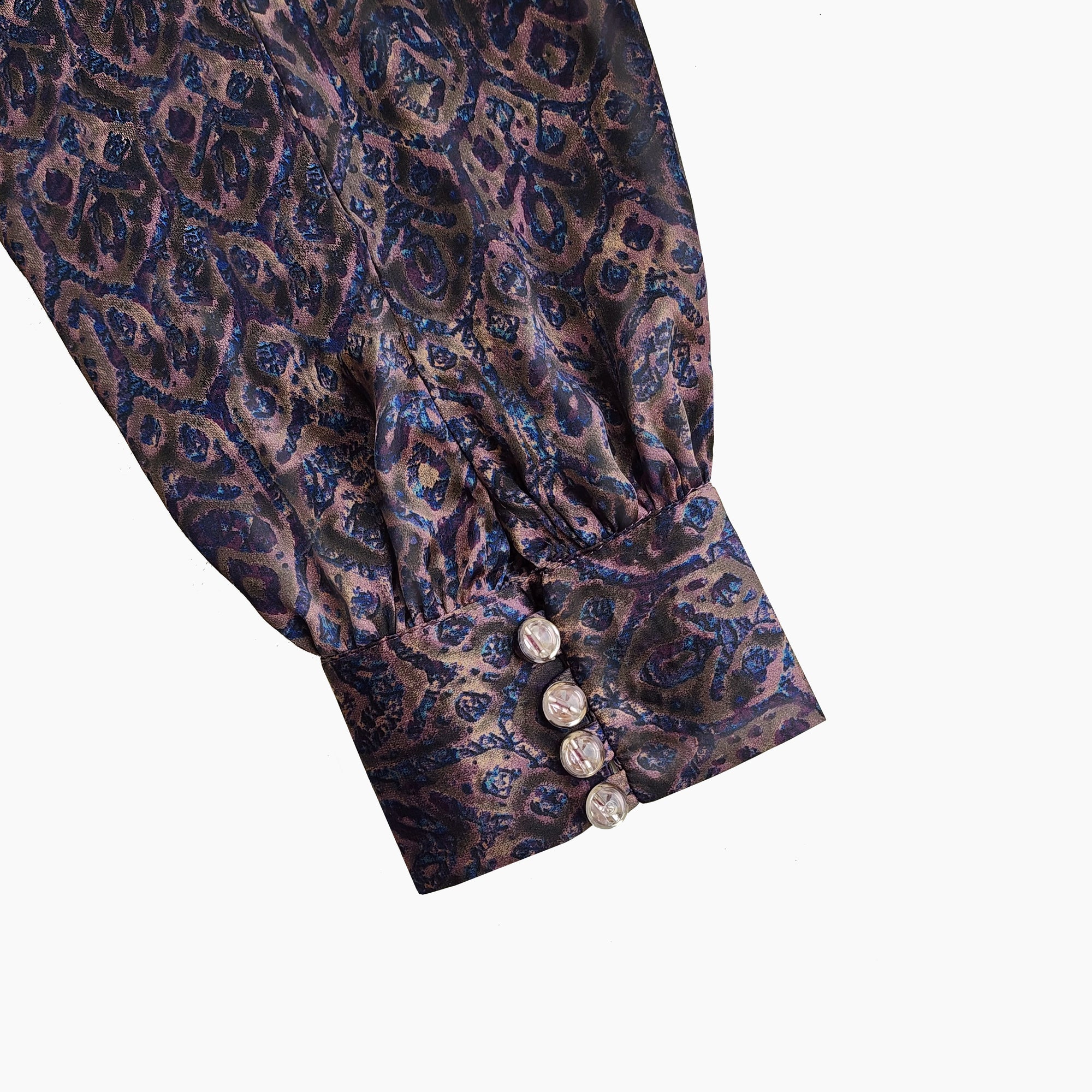 Close-up of quarter bishop sleeve with button & hook accents