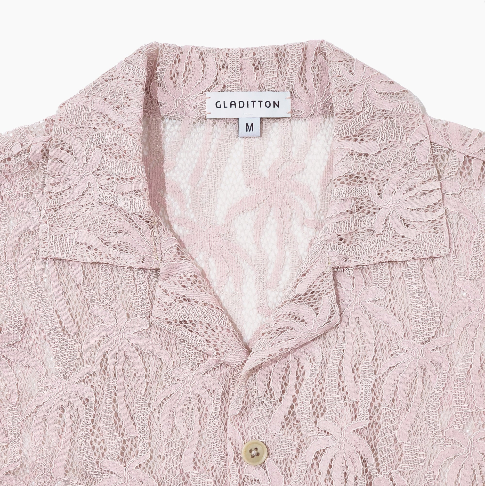Close-up of collar and lace texture on soft blush button-up shirt with detailed palm pattern